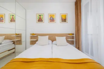 a bedroom with a large white bed with two pillows at Fabryczna Modern Apartment with Balcony & Parking in Cracow by Noclegi Renters in Kraków