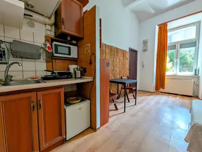 a small kitchen with a sink and a table at Krowoderska 53 by Homeprime in Kraków