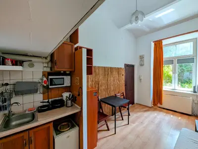 a small kitchen with a sink and a table at Krowoderska 53 by Homeprime in Kraków