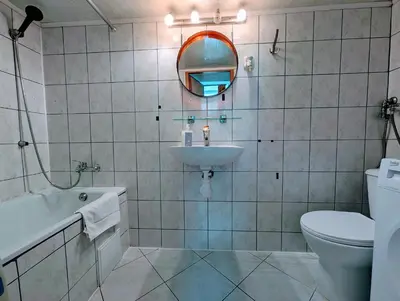 a bathroom with a sink and a toilet and a mirror at Krowoderska 53 by Homeprime in Kraków