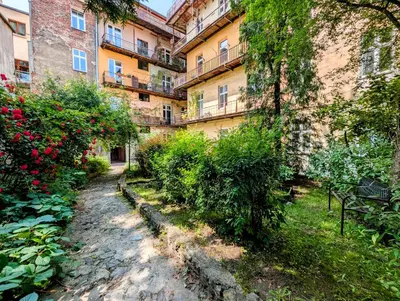 an alley in front of a building with bushes at Krowoderska 53 by Homeprime in Kraków