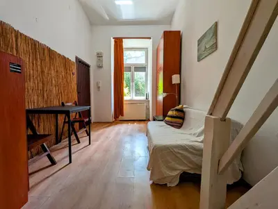 a bedroom with a bed and a desk in it at Krowoderska 53 by Homeprime in Kraków