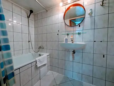 a bathroom with a sink and a tub and a mirror at Krowoderska 53 by Homeprime in Kraków