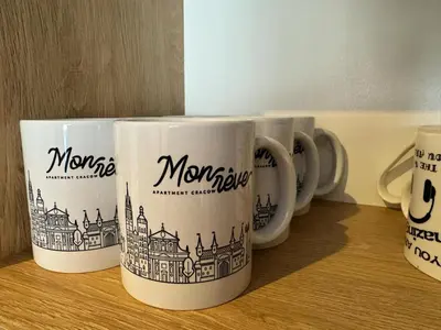 four coffee mugs sitting on top of a table at Mon Rêve in Kraków