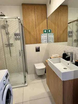 a bathroom with a sink and a toilet and a shower at Mon Rêve in Kraków