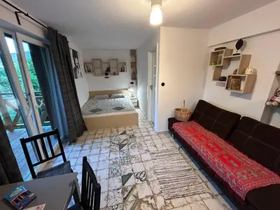 a living room with a couch and a bedroom at W górach nad strumieniem in Bieńkówka