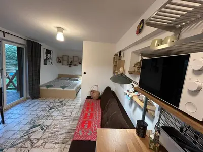 a living room with a large flat screen tv at W górach nad strumieniem in Bieńkówka