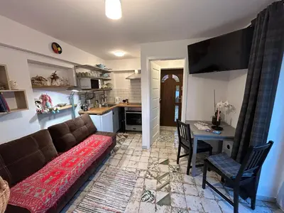 a living room with a couch and a table at W górach nad strumieniem in Bieńkówka