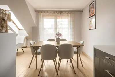 a dining room with a table and chairs at Apartament na Skarpie in Rabka