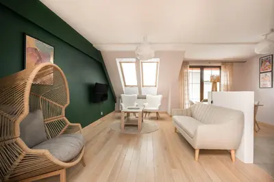 a living room with a couch and a chair at Apartament na Skarpie in Rabka