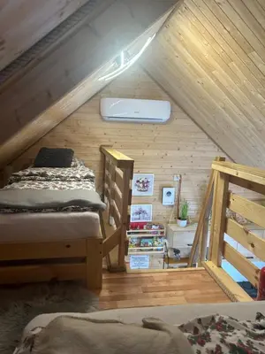 a bedroom with two bunk beds in a attic at Sosnowy Domek in Zator