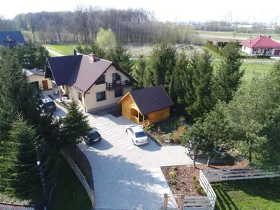 an aerial view of a house with a car parked in a driveway at Sosnowy Domek in Zator