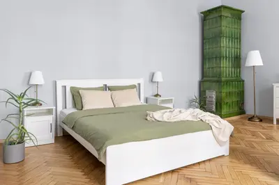 a bedroom with a white bed and two lamps at ANTA Apartments Warszawska in Kraków