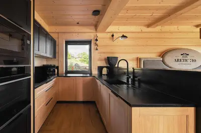 a kitchen with a black counter top in a cabin at Arete' 710 Stryszawa in Stryszawa