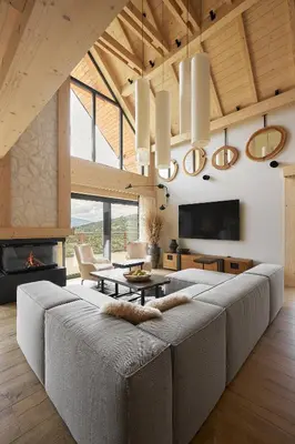 a living room with a large couch and a fireplace at Arete' 710 Stryszawa in Stryszawa