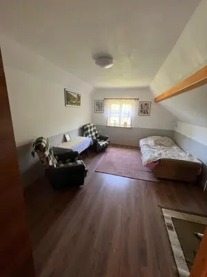a living room with a bed and a couch at Dom pod Świerczkiem in Słopnice