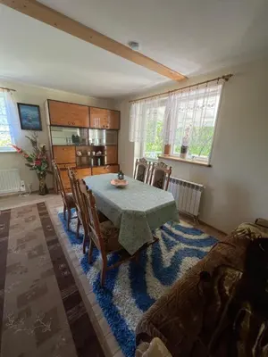 a dining room with a table and chairs at Dom pod Świerczkiem in Słopnice