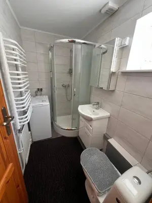 a bathroom with a shower and a toilet and a sink at Dom pod Świerczkiem in Słopnice