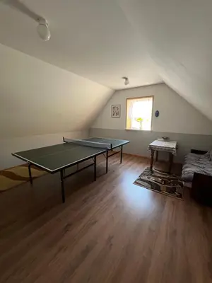 a room with two ping pong tables in a attic at Dom pod Świerczkiem in Słopnice