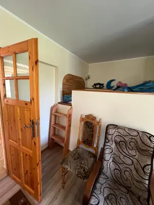 a room with a bed and a door and a bedroom at Dom pod Świerczkiem in Słopnice