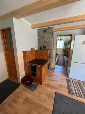 a kitchen with a stove top oven in a room at Dom pod Świerczkiem in Słopnice