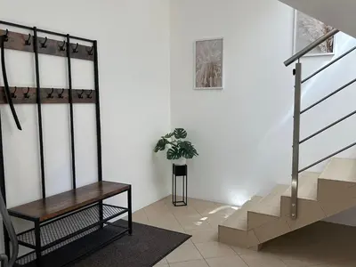 a staircase with a potted plant in a room at AP Apartament in Kraków