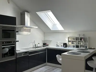 a kitchen with a sink and a stove top oven at AP Apartament in Kraków