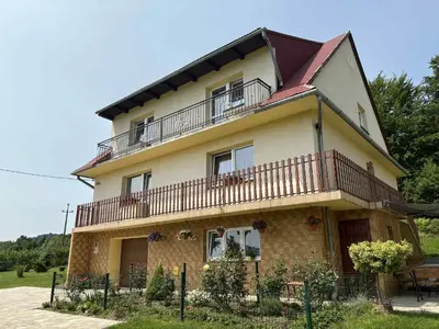 a large house with a balcony on top of it at Noclegi w Beskidzie Wyspowym in Przenosza