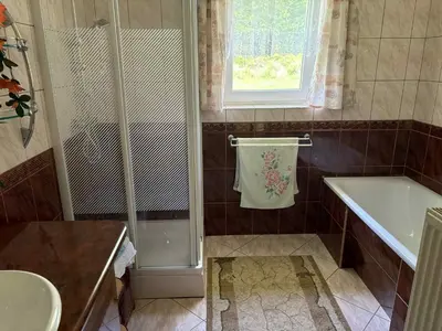 a bathroom with a shower and a sink at Noclegi w Beskidzie Wyspowym in Przenosza