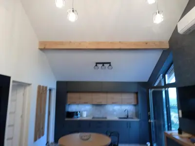 a kitchen with blue walls and a wooden table at Panorama Resort in Radocza