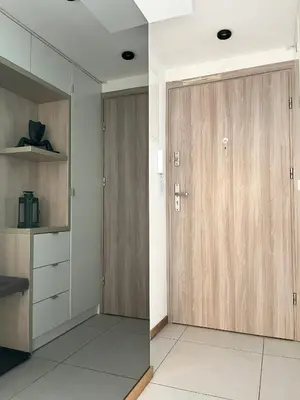 a room with wooden doors and a white floor at Modern Apartments with Air Conditioning, Vistula Boulevards, Cracow city heart in Kraków