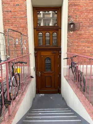 a wooden door with two bikes parked in front of a building at Modern Apartments with Air Conditioning, Vistula Boulevards, Cracow city heart in Kraków