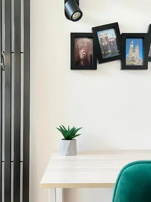a room with a table and pictures on the wall at Modern Apartments with Air Conditioning, Vistula Boulevards, Cracow city heart in Kraków