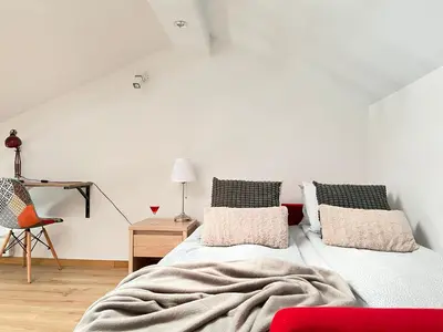 a bedroom with a bed and a table and a chair at Modern Apartments with Air Conditioning, Vistula Boulevards, Cracow city heart in Kraków
