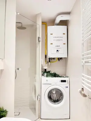 a small bathroom with a washing machine in it at Modern Apartments with Air Conditioning, Vistula Boulevards, Cracow city heart in Kraków