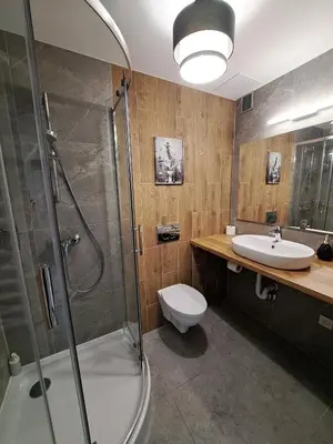 a kitchen counter with a sink and a microwave at RentApart in Kraków