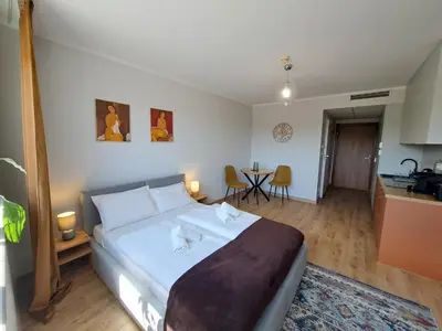 a living room with a bed and a couch in a room at RentApart in Kraków