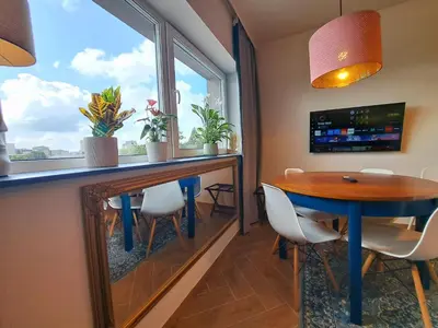 a dining room with a table and a window at RentApart in Kraków