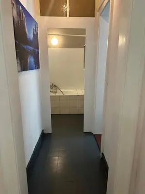 a hallway of a bathroom with a bath tub at City Center Rooms in Kraków