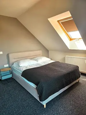 a bedroom with a large bed with a skylight at Willa za Zeliną
