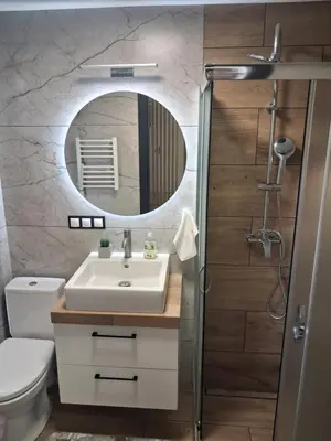 a bathroom with a sink and a mirror at Domek u Oli - blisko Energylandia, Wadowice, Kraków, Oświęcim in Bachowice
