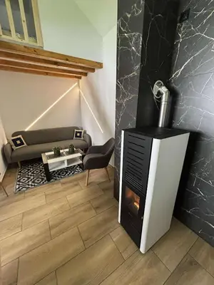 a living room with a fireplace and a couch at Domek u Oli - blisko Energylandia, Wadowice, Kraków, Oświęcim in Bachowice
