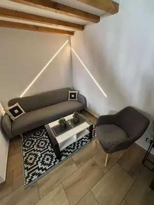 a living room with a couch and a chair at Domek u Oli - blisko Energylandia, Wadowice, Kraków, Oświęcim in Bachowice