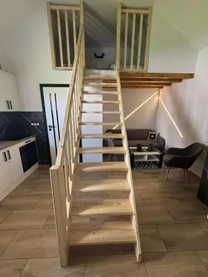 a wooden staircase in a living room with a couch at Domek u Oli - blisko Energylandia, Wadowice, Kraków, Oświęcim in Bachowice