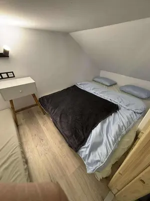 a bed in a small room with a nightstand and a bed sidx sidx sidx at Domek u Oli - blisko Energylandia, Wadowice, Kraków, Oświęcim in Bachowice