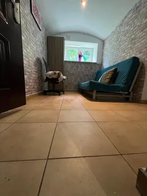 a living room with a couch and a window at Kawalerka-Studio underground in Kraków