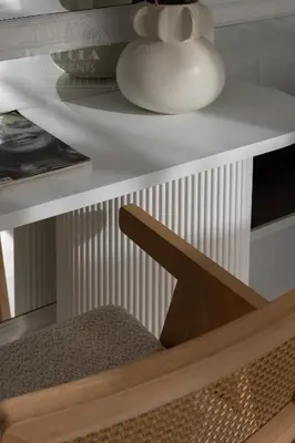 a white table with a chair and a vase on it at Fragola Apartments Florian Gate in Kraków