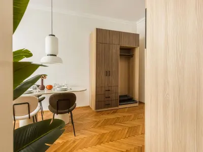 a kitchen and dining room with a table and chairs at Fragola Apartments Florian Gate in Kraków