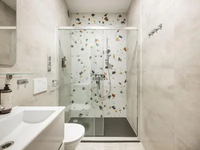 a bathroom with a shower and a toilet at Fragola Apartments Florian Gate in Kraków