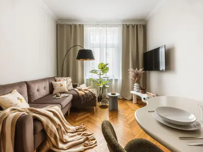 a living room with a couch and a table at Fragola Apartments Florian Gate in Kraków